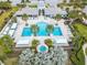 Aerial view of the community pool, spa, cabanas, and palm trees at 3603 Woodmont Dr, Parrish, FL 34219