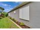 Home exterior featuring hurricane shutters, a landscaped yard, and a manicured lawn at 3603 Woodmont Dr, Parrish, FL 34219