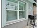 View of exterior window with blinds and outdoor seating area by the pool at 3603 Woodmont Dr, Parrish, FL 34219