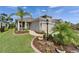 Charming single-Gathering home featuring a well-manicured lawn, landscaped garden beds, and a two-car garage at 3603 Woodmont Dr, Parrish, FL 34219