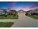 Charming single-Gathering home featuring a well-manicured lawn, landscaped garden beds, and a two-car garage at 3603 Woodmont Dr, Parrish, FL 34219