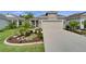 Charming single-Gathering home featuring a well-manicured lawn, landscaped garden beds, and a two-car garage at 3603 Woodmont Dr, Parrish, FL 34219