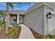 Inviting front porch featuring a cozy seating area and a beautifully adorned front door with wreath at 3603 Woodmont Dr, Parrish, FL 34219