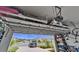 Spacious garage with overhead racks, showcasing storage capacity and vehicle parking with outdoor view at 3603 Woodmont Dr, Parrish, FL 34219