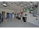 Garage with epoxy floor, tool storage, overhead storage, and bike hanging on the wall at 3603 Woodmont Dr, Parrish, FL 34219