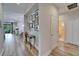 Hallway with views of the dining area and bathroom, featuring stylish decor and flooring at 3603 Woodmont Dr, Parrish, FL 34219