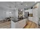 Kitchen featuring granite island, stainless appliances, and an adjacent dining area at 3603 Woodmont Dr, Parrish, FL 34219