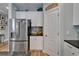 Bright kitchen includes stainless steel refrigerator and white cabinets at 3603 Woodmont Dr, Parrish, FL 34219