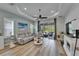 Spacious living room with a ceiling fan and sliding glass doors leading to the outdoor area at 3603 Woodmont Dr, Parrish, FL 34219