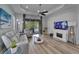 Comfortable living room with fireplace and sliding door access to screened porch at 3603 Woodmont Dr, Parrish, FL 34219