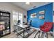 Bright office featuring a vivid blue accent wall, modern desk, and comfortable seating, a great place to work at 3603 Woodmont Dr, Parrish, FL 34219