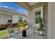 Charming patio with comfortable seating and a view of the landscaped yard, creating a relaxing outdoor space at 3603 Woodmont Dr, Parrish, FL 34219