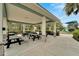 Community picnic pavilion featuring multiple picnic tables, shade and a view of the playground at 3603 Woodmont Dr, Parrish, FL 34219