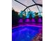 Backyard pool with colorful LED lights at night at 3603 Woodmont Dr, Parrish, FL 34219