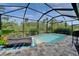 Exterior view of outdoor pool and lounge chairs surrounded by screened lanai at 3603 Woodmont Dr, Parrish, FL 34219