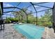 Refreshing pool with screened enclosure offers a private oasis with lush landscaping at 3603 Woodmont Dr, Parrish, FL 34219