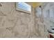 Tiled shower includes updated showerhead and niche for storage at 3603 Woodmont Dr, Parrish, FL 34219