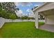Lush backyard featuring a well-manicured lawn and white vinyl fence at 3614 W Platt St, Tampa, FL 33609