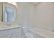 Bright bathroom with a tub, shower, vanity with white marble countertops, and sleek, modern fixtures at 3614 W Platt St, Tampa, FL 33609