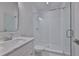 Modern bathroom featuring a glass enclosed shower and a marble-top vanity, providing a spa-like experience at 3614 W Platt St, Tampa, FL 33609