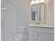 Modern bathroom featuring a glass-enclosed shower and white vanity with a marble countertop at 3614 W Platt St, Tampa, FL 33609