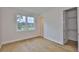 Sunlit bedroom featuring hardwood floors, a window, and an open doorway to a walk-in closet at 3614 W Platt St, Tampa, FL 33609
