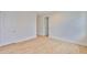 Bedroom featuring hardwood floors, a doorway, and clean, modern design, plus multiple electrical outlets at 3614 W Platt St, Tampa, FL 33609