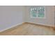 Bedroom featuring hardwood floors, a large window, and neutral paint at 3614 W Platt St, Tampa, FL 33609