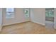 Bright bedroom with hardwood floors and windows offering neighborhood views at 3614 W Platt St, Tampa, FL 33609