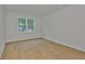 Spacious bedroom with a large window, wood flooring, and neutral paint at 3614 W Platt St, Tampa, FL 33609