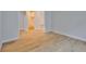 Bright bedroom with light hardwood floors and a view into the closet and hallway at 3614 W Platt St, Tampa, FL 33609