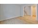 Bedroom with hardwood floors, baseboards, an open entry to stairs and doorway to another room at 3614 W Platt St, Tampa, FL 33609
