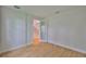 Bright bedroom showcasing hardwood floors, white walls, baseboards and glass paneled door at 3614 W Platt St, Tampa, FL 33609