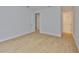 A bright bedroom with light hardwood floors and an ensuite bathroom for convenient, modern living at 3614 W Platt St, Tampa, FL 33609