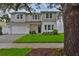 Attractive two-story home with manicured lawn, a brick driveway and neat front yard landscaping at 3614 W Platt St, Tampa, FL 33609