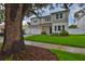 Two-story home with manicured lawn, a brick driveway, tidy front landscaping and neutral color palette at 3614 W Platt St, Tampa, FL 33609