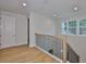 Hallway with hardwood floors, a staircase, and natural light at 3614 W Platt St, Tampa, FL 33609