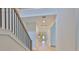 Upstairs hallway featuring wood railings and floors, bright white walls, and recessed ceiling lights at 3614 W Platt St, Tampa, FL 33609