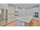 Contemporary kitchen featuring stainless steel appliances, sleek white cabinets, and a spacious island with a marble countertop at 3614 W Platt St, Tampa, FL 33609