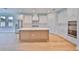 Expansive kitchen showcasing a large island, stainless appliances, and white cabinetry with modern hardware at 3614 W Platt St, Tampa, FL 33609