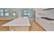 Modern kitchen featuring stainless steel appliances, a spacious island, and white cabinetry at 3614 W Platt St, Tampa, FL 33609