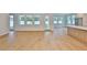 Bright open-concept living room with hardwood floors, white walls, and backyard access at 3614 W Platt St, Tampa, FL 33609