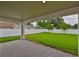 Covered patio overlooking a large, green backyard and white fence at 3614 W Platt St, Tampa, FL 33609