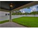 The covered patio overlooks a spacious, well-manicured backyard with a white fence at 3616 W Platt St, Tampa, FL 33609