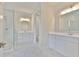 Bathroom featuring marble floors, double vanities, and a glass shower at 3616 W Platt St, Tampa, FL 33609