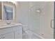 Well-lit bathroom features a single sink vanity and a glass-enclosed shower at 3616 W Platt St, Tampa, FL 33609
