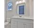 Bright bathroom features a white vanity with a marble countertop and modern fixtures at 3616 W Platt St, Tampa, FL 33609