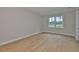 Spacious bedroom with hardwood floors and natural light from a large window at 3616 W Platt St, Tampa, FL 33609