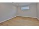 Finished bedroom featuring light hardwood floors, modern lighting, and natural light at 3616 W Platt St, Tampa, FL 33609