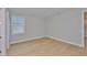 Bedroom with hardwood floors, one window, and white trim at 3616 W Platt St, Tampa, FL 33609